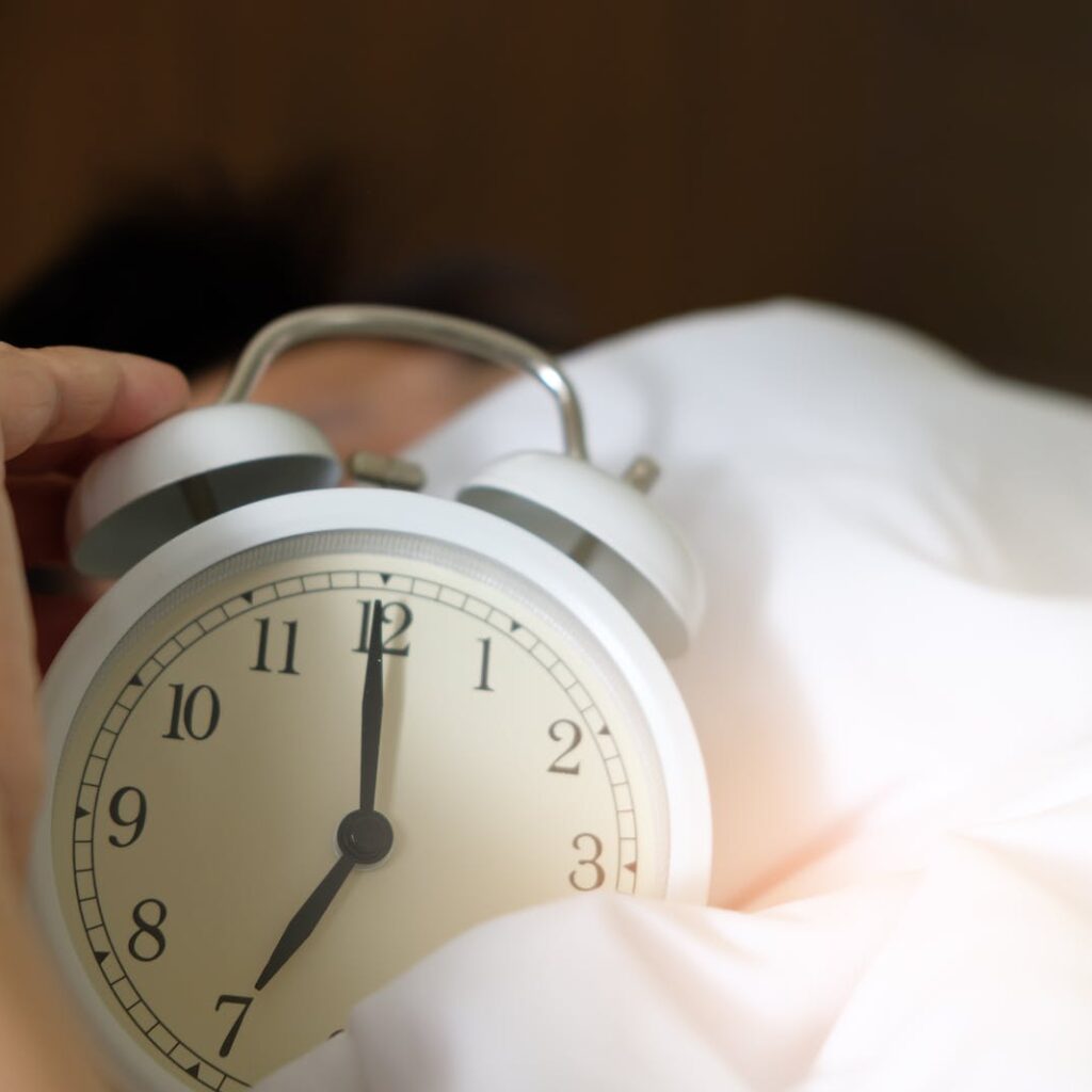Photo of Person Holding Alarm Clock
